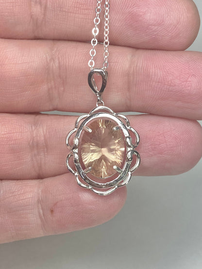 Sterling silver pendant necklace featuring a large oval fancy cut Oregon Sunstone.