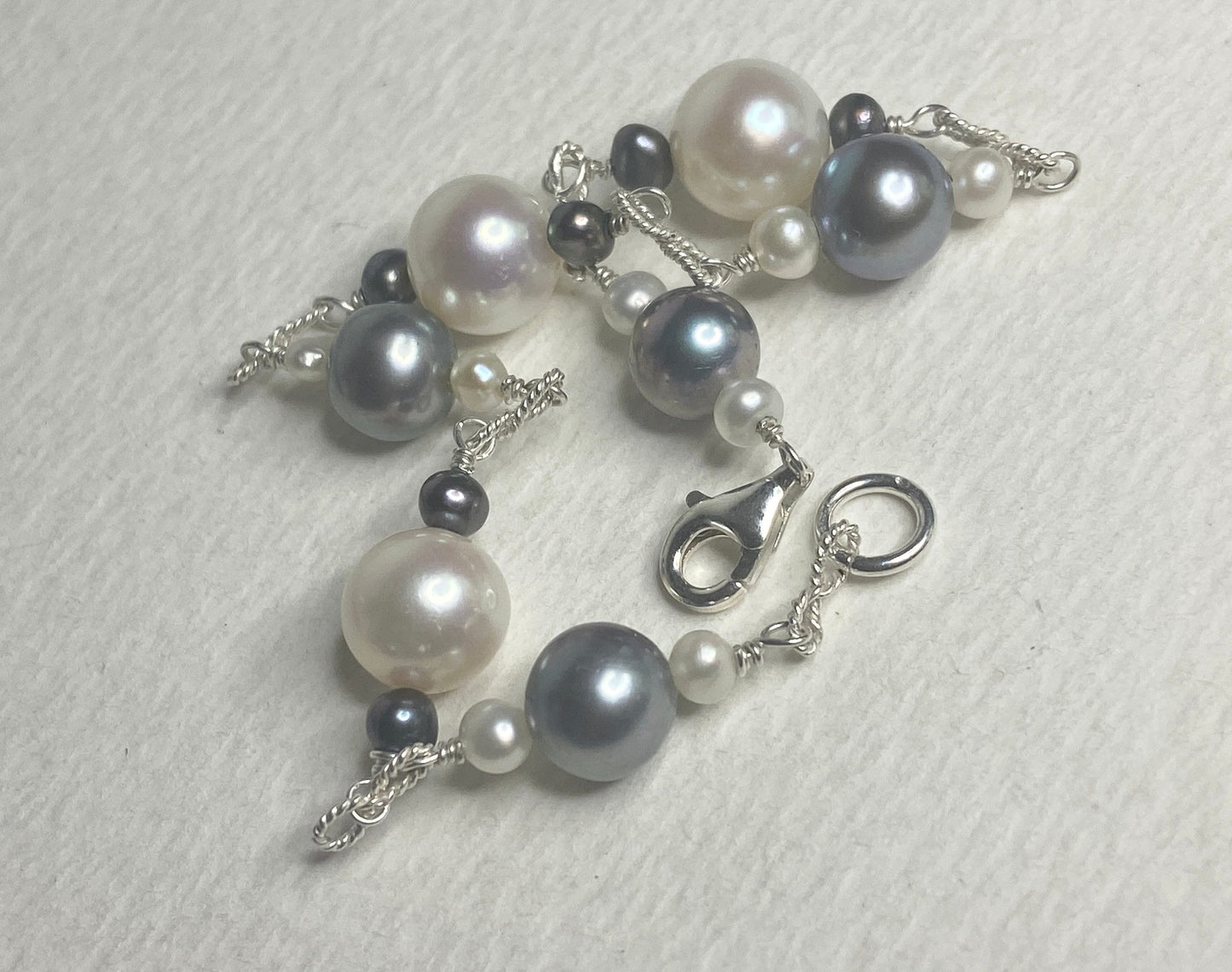Sterling silver bracelet with Akoya, Tahitian, and freshwater pearls in black and white.