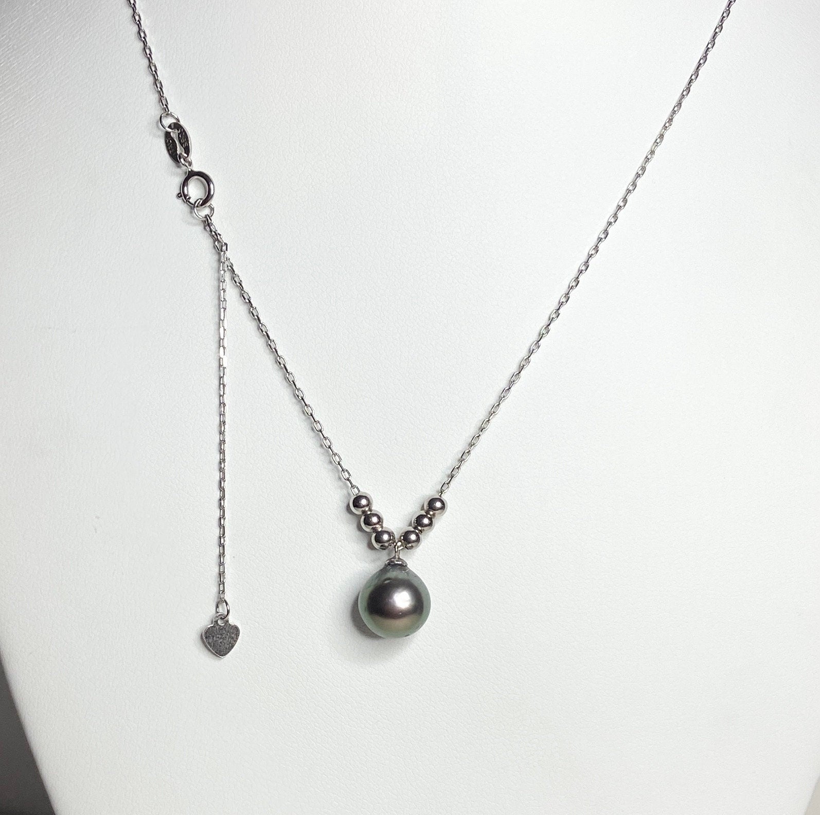 Sterling silver necklace with a Tahitian pearl pendant and adjustable chain.