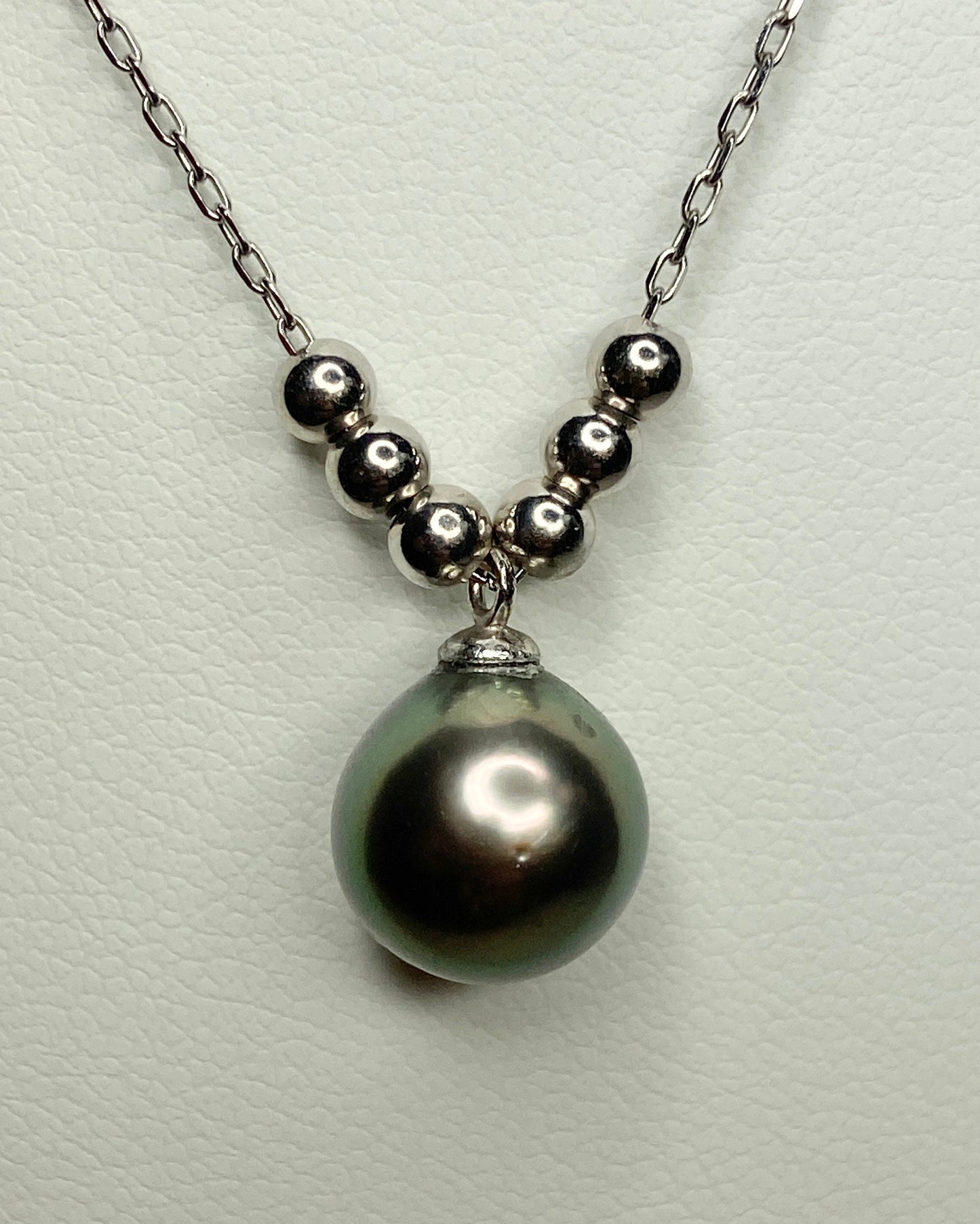 Sterling silver necklace with a Tahitian pearl pendant and floating beads.