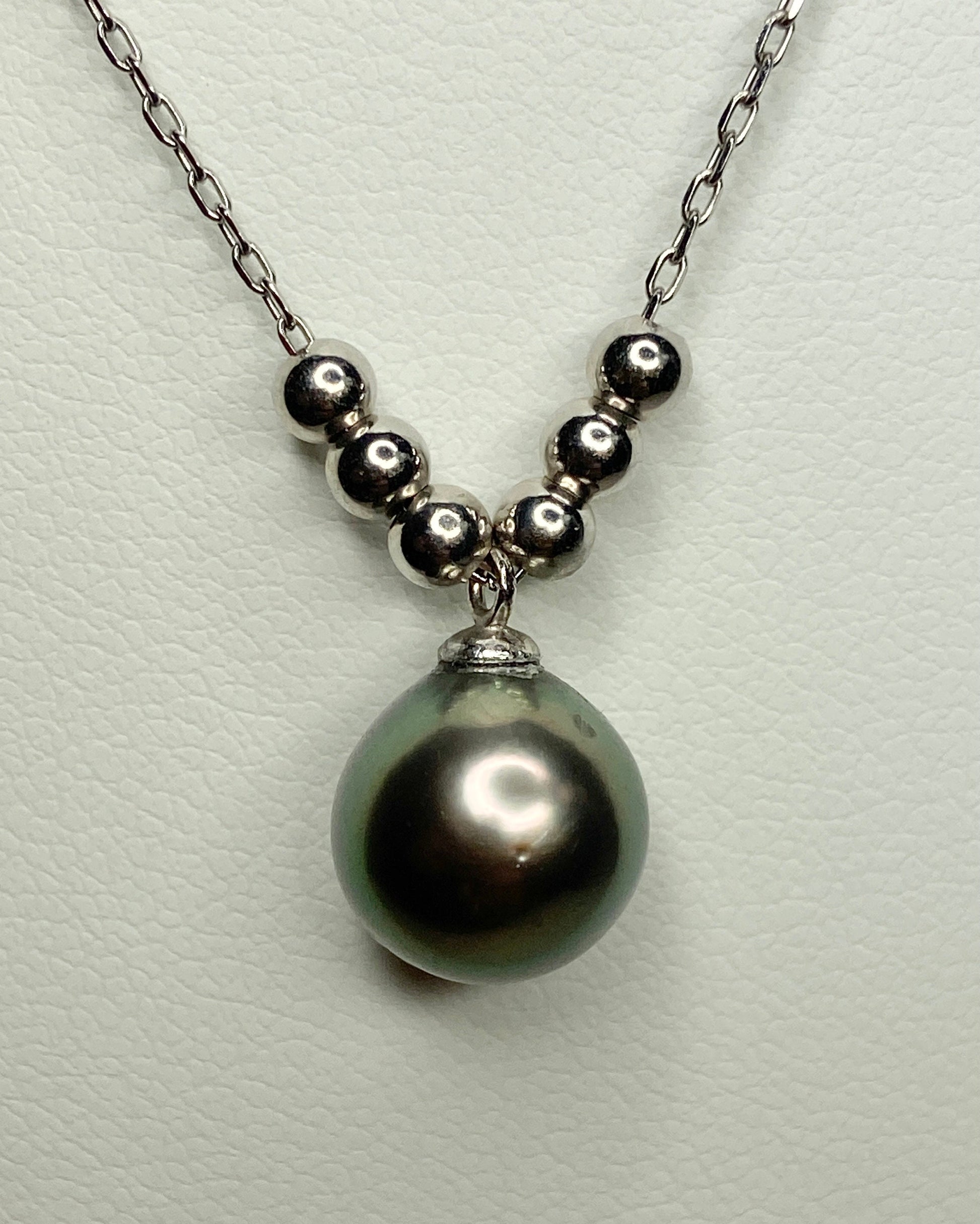 Sterling silver necklace with a Tahitian pearl pendant and floating beads.