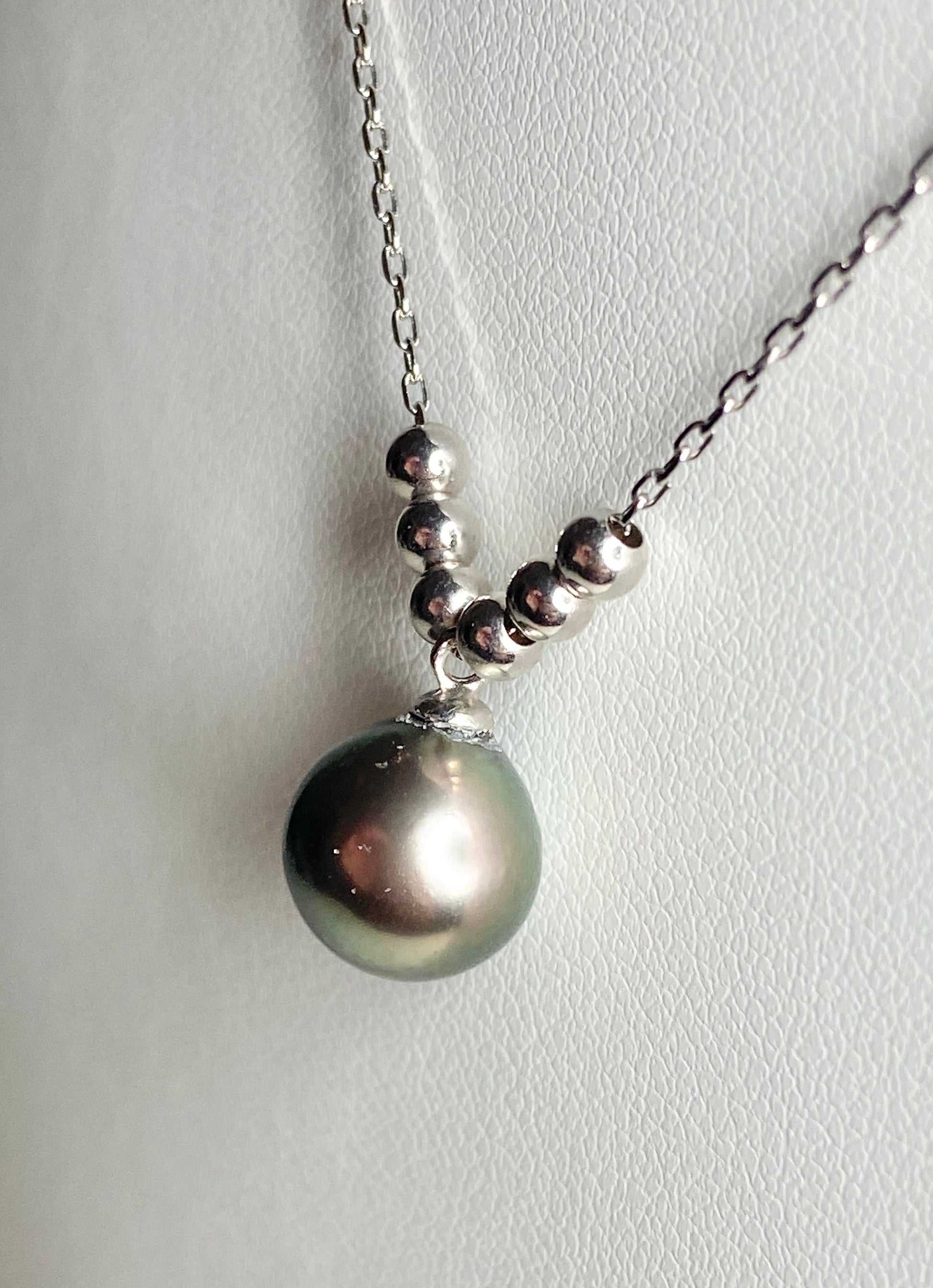 Sterling silver necklace with a Tahitian pearl pendant and floating beads.