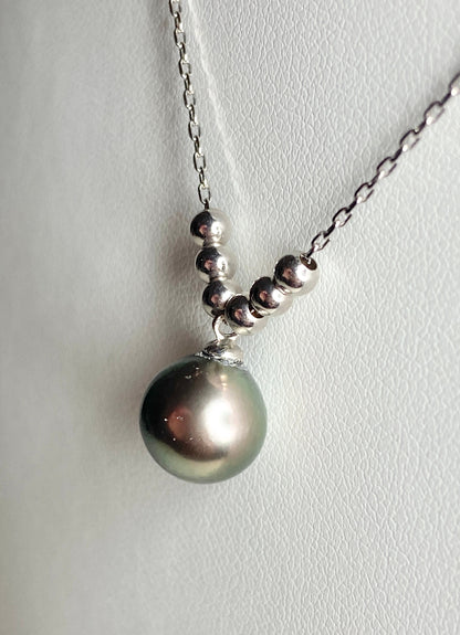 Sterling silver necklace with a Tahitian pearl pendant and floating beads.