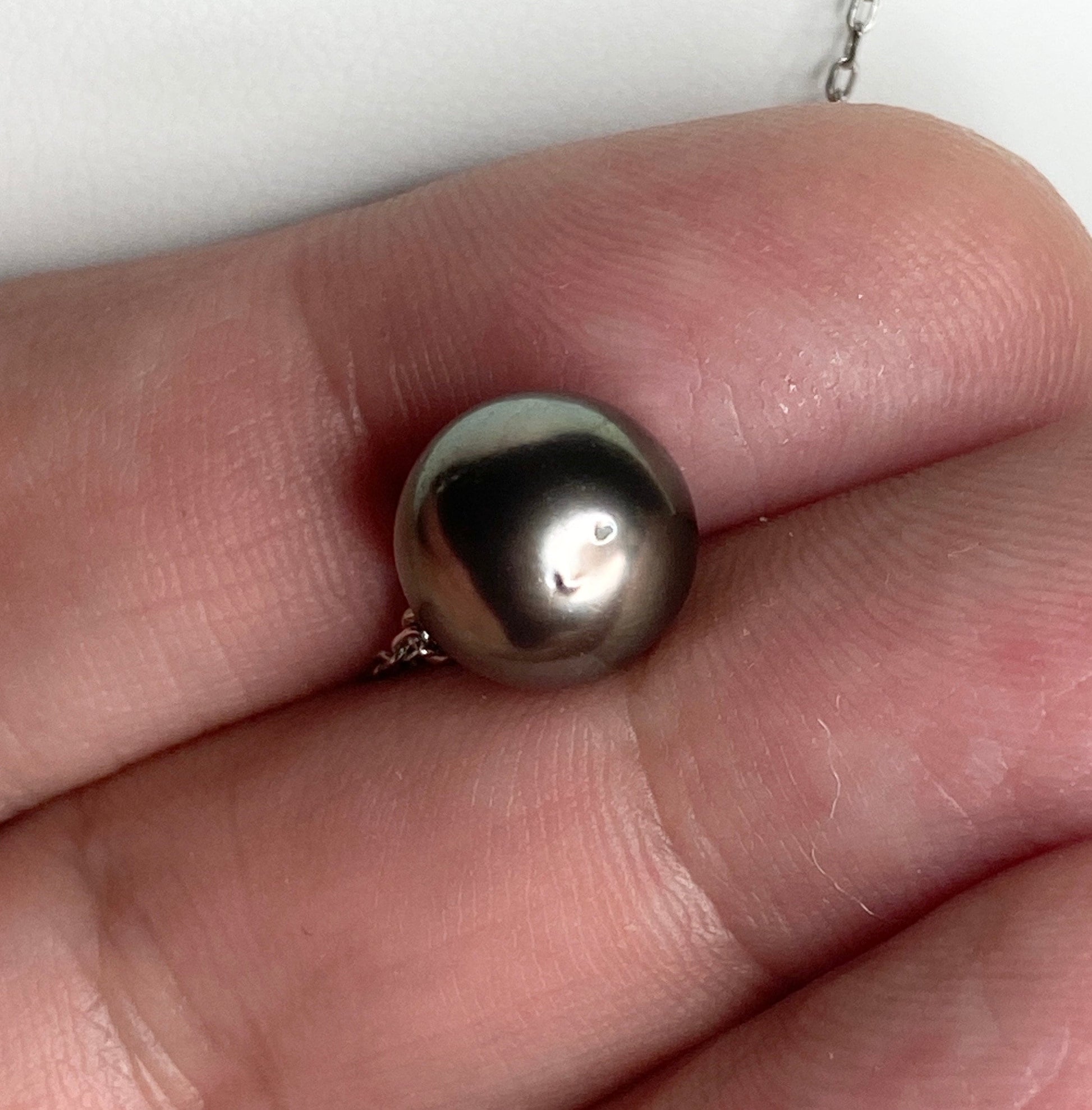 A Tahitian pearl pendant with beads on a sterling silver chain.