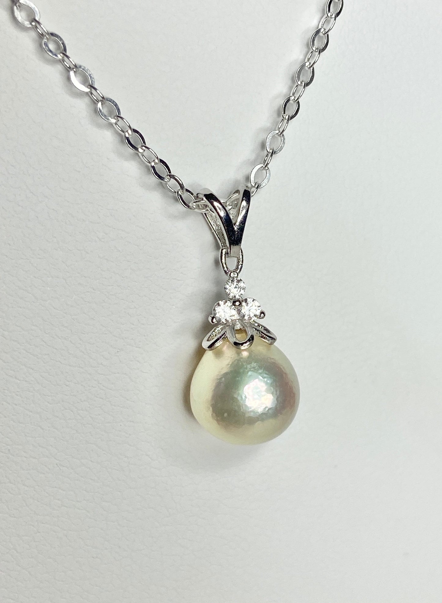 Sterling silver necklace with a high luster, out-of-round cultured pearl and crystal accents.