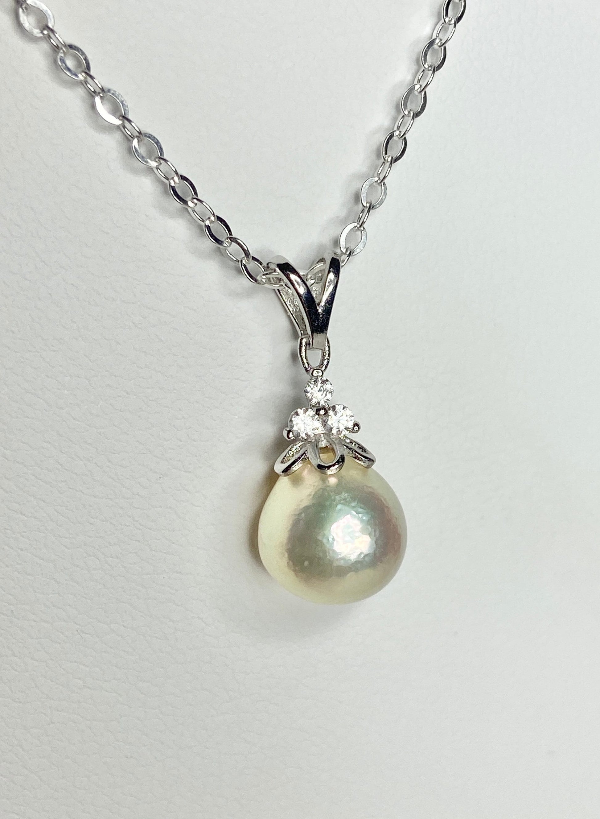 Sterling silver necklace with a high luster, out-of-round cultured pearl and crystal accents.