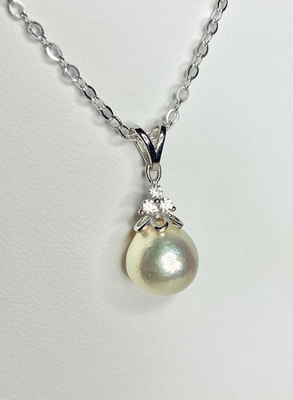 Sterling silver necklace with a high luster, out-of-round cultured pearl and crystal accents.