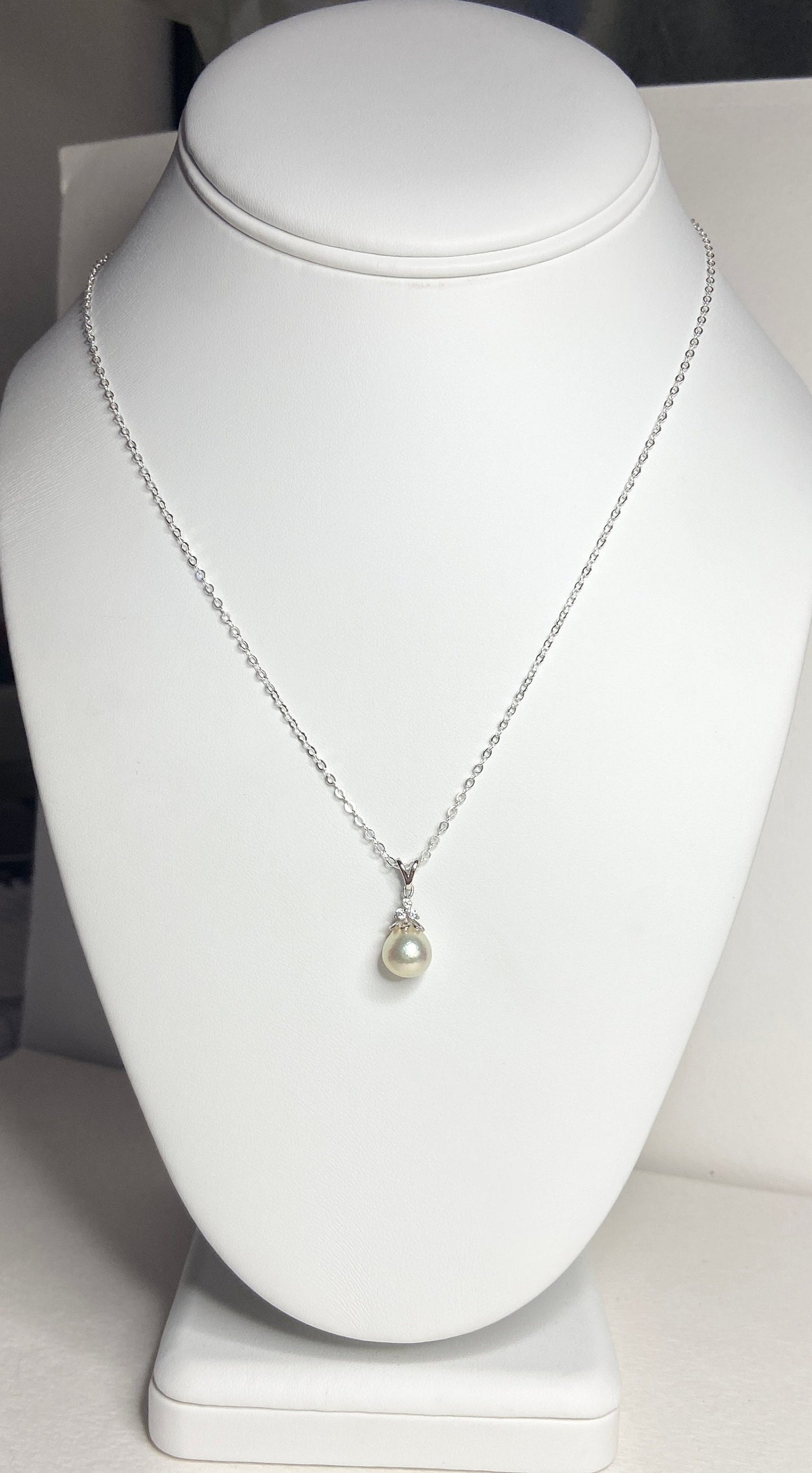 Sterling silver necklace with a tear-shaped Akoya pearl and crystal accents.