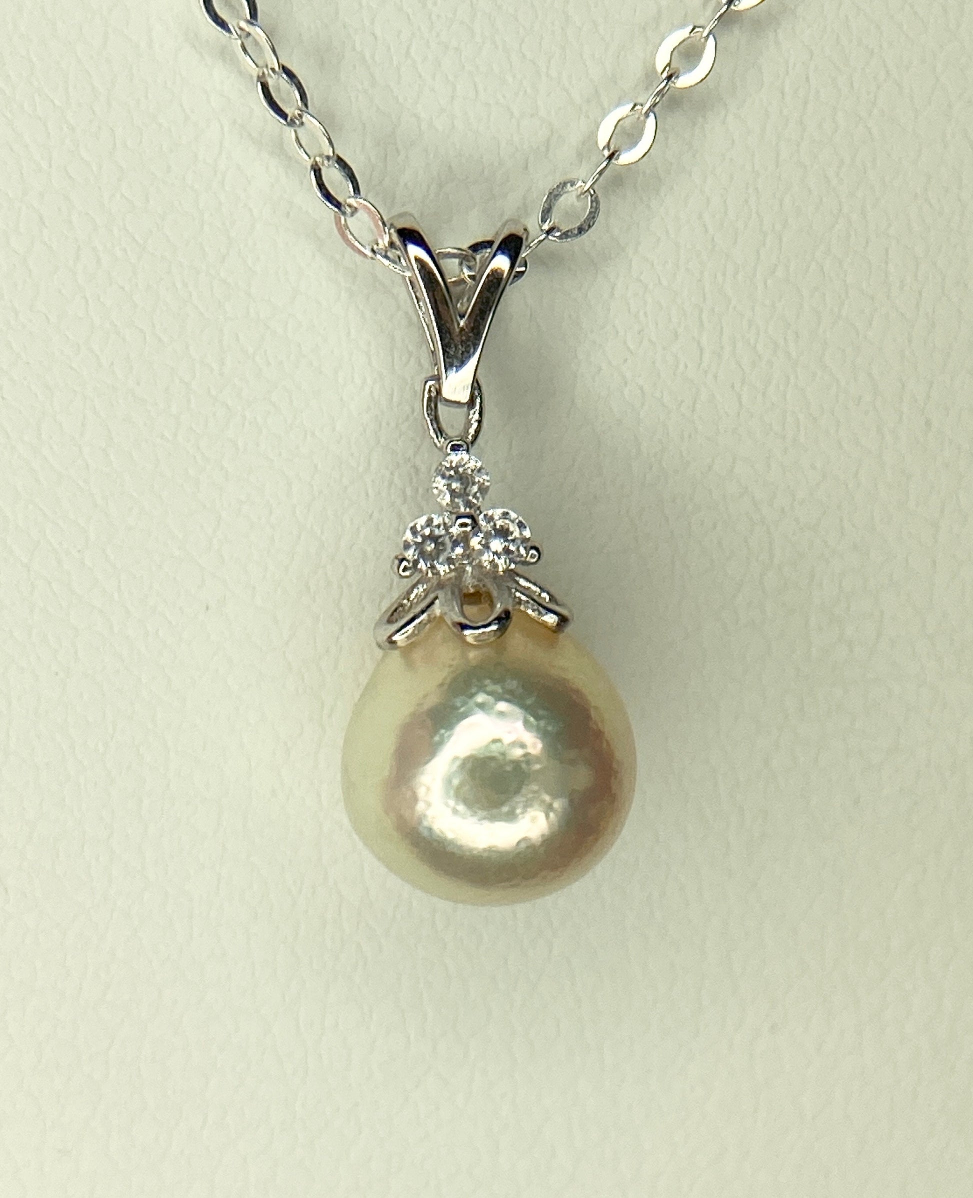 Sterling silver necklace with an out-of-round Akoya pearl and crystal accents.