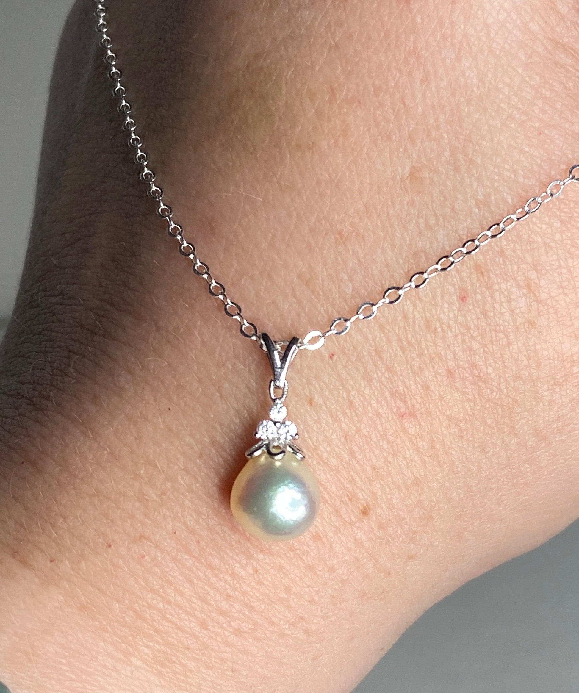 Sterling silver necklace with a tear-shaped Akoya pearl and crystal accents.