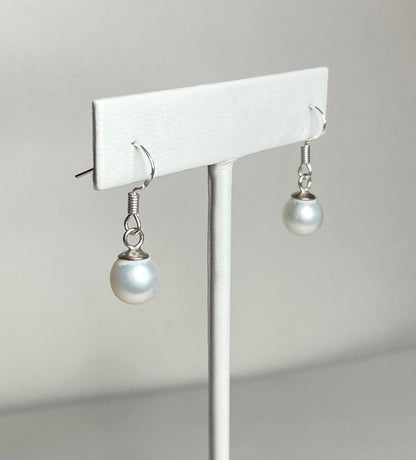 Sterling silver dangle earrings with 8mm white freshwater pearls.