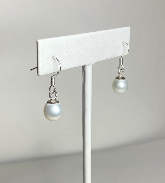 Sterling silver dangle earrings with 8mm white freshwater pearls.