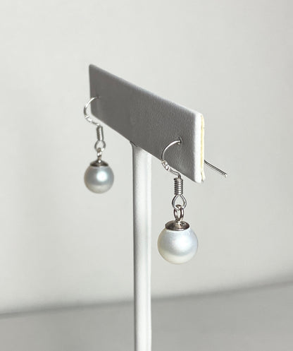 Sterling silver dangle earrings with 8mm white freshwater pearls.