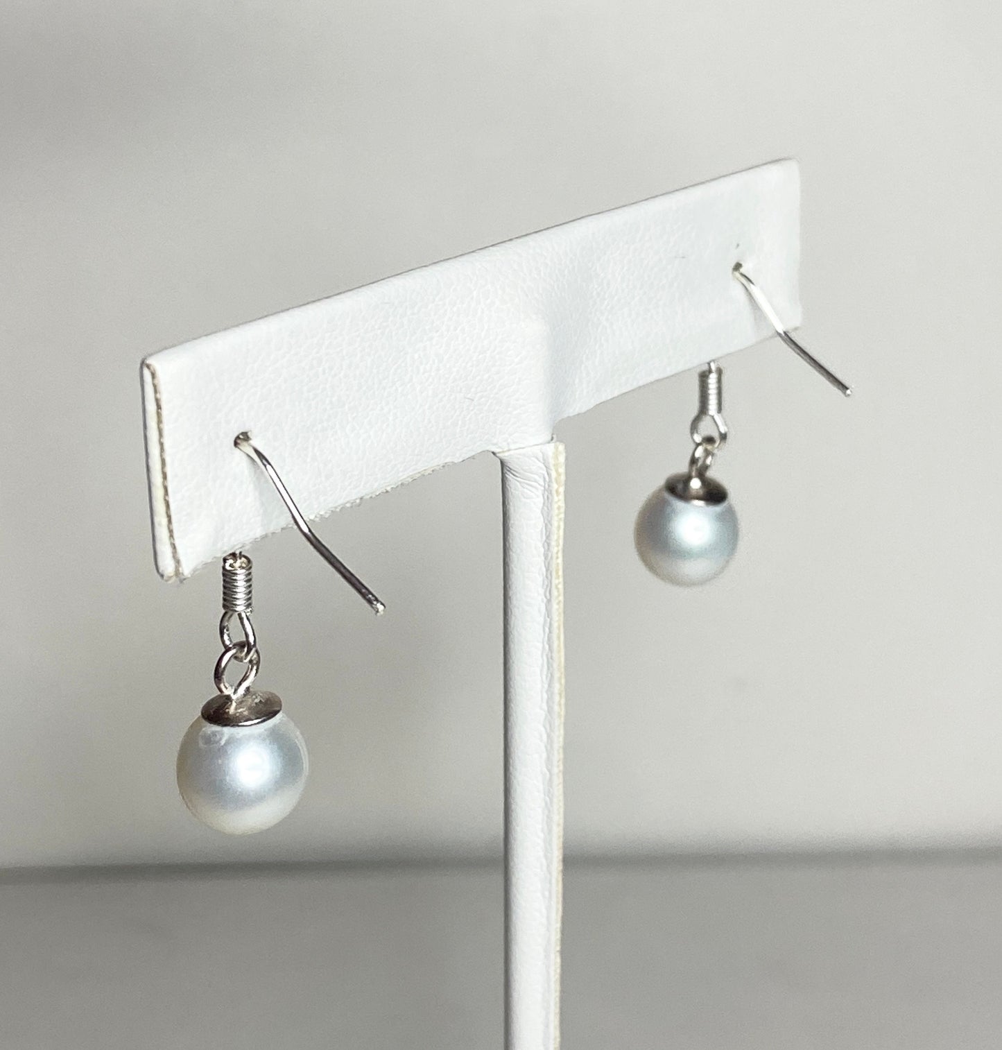 Sterling silver dangle earrings with 8mm white cultured pearls.