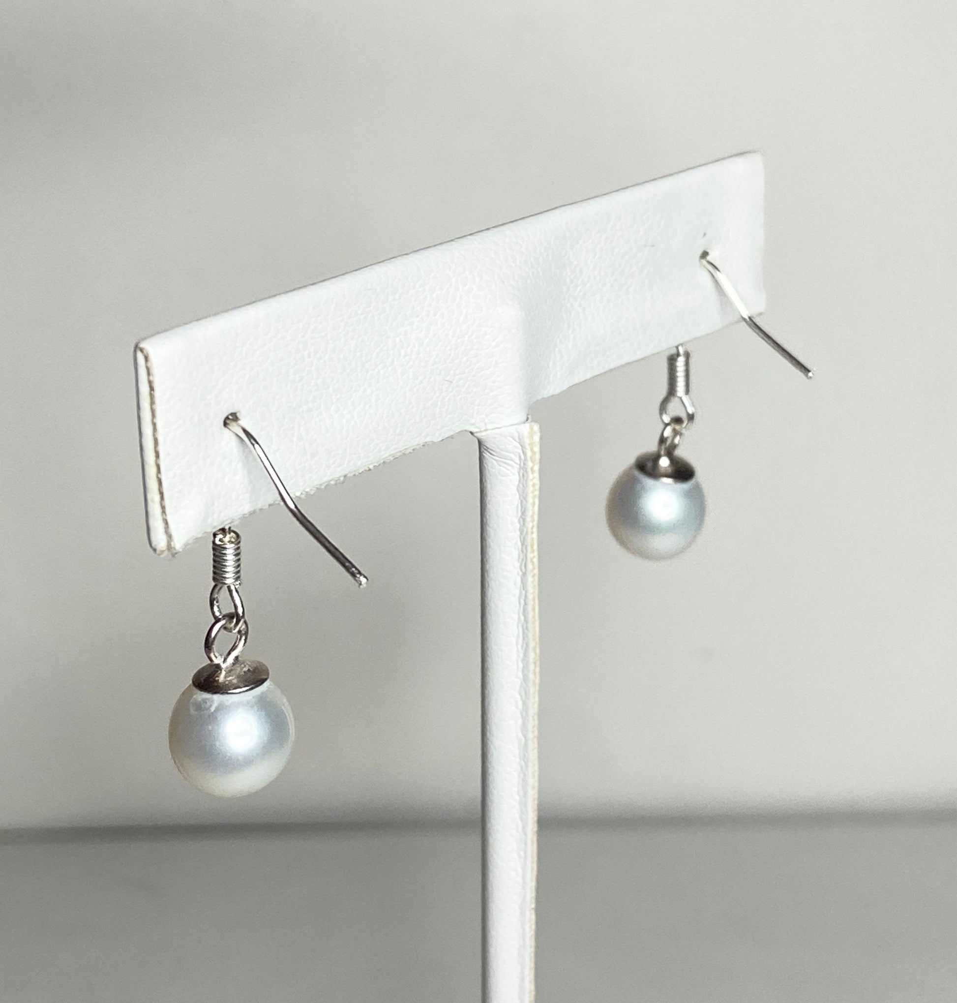 Sterling silver dangle earrings with 8mm white cultured pearls.