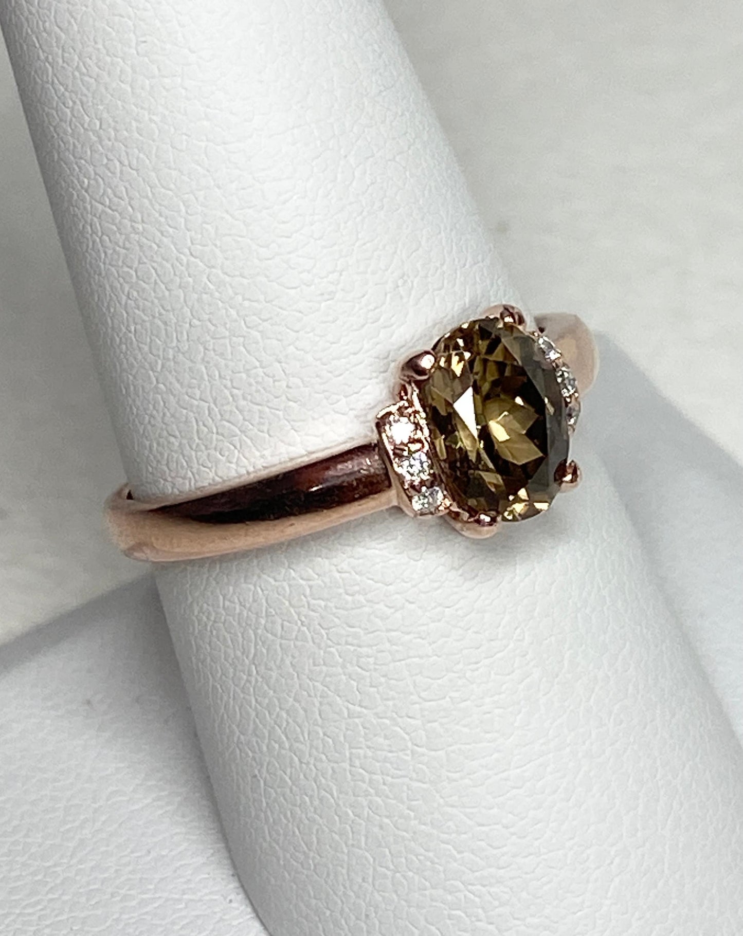 Oval greenish-gold zircon and diamond ring in 10k rose gold.