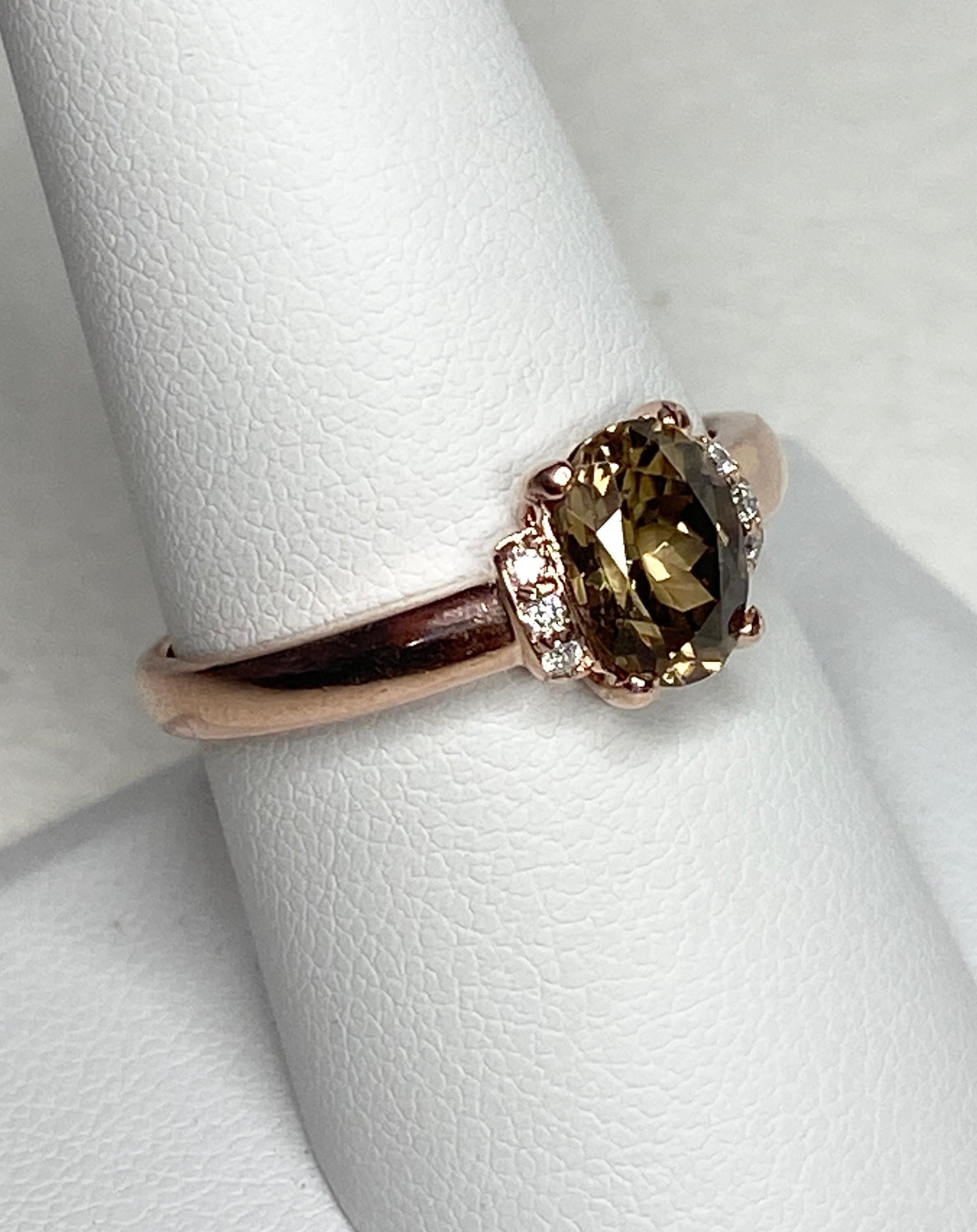 Oval greenish-gold zircon and diamond ring in 10k rose gold.
