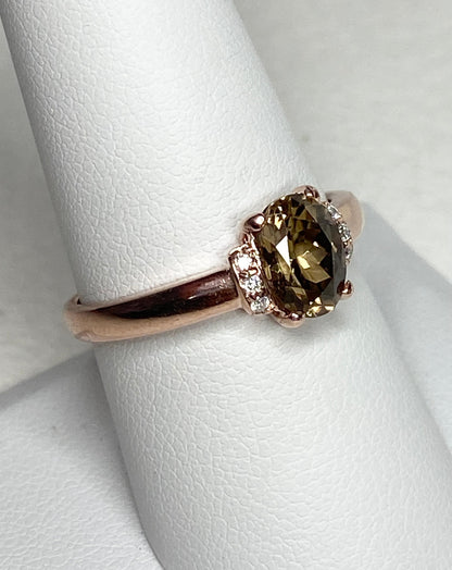 Oval greenish-gold zircon and diamond ring in 10k rose gold.
