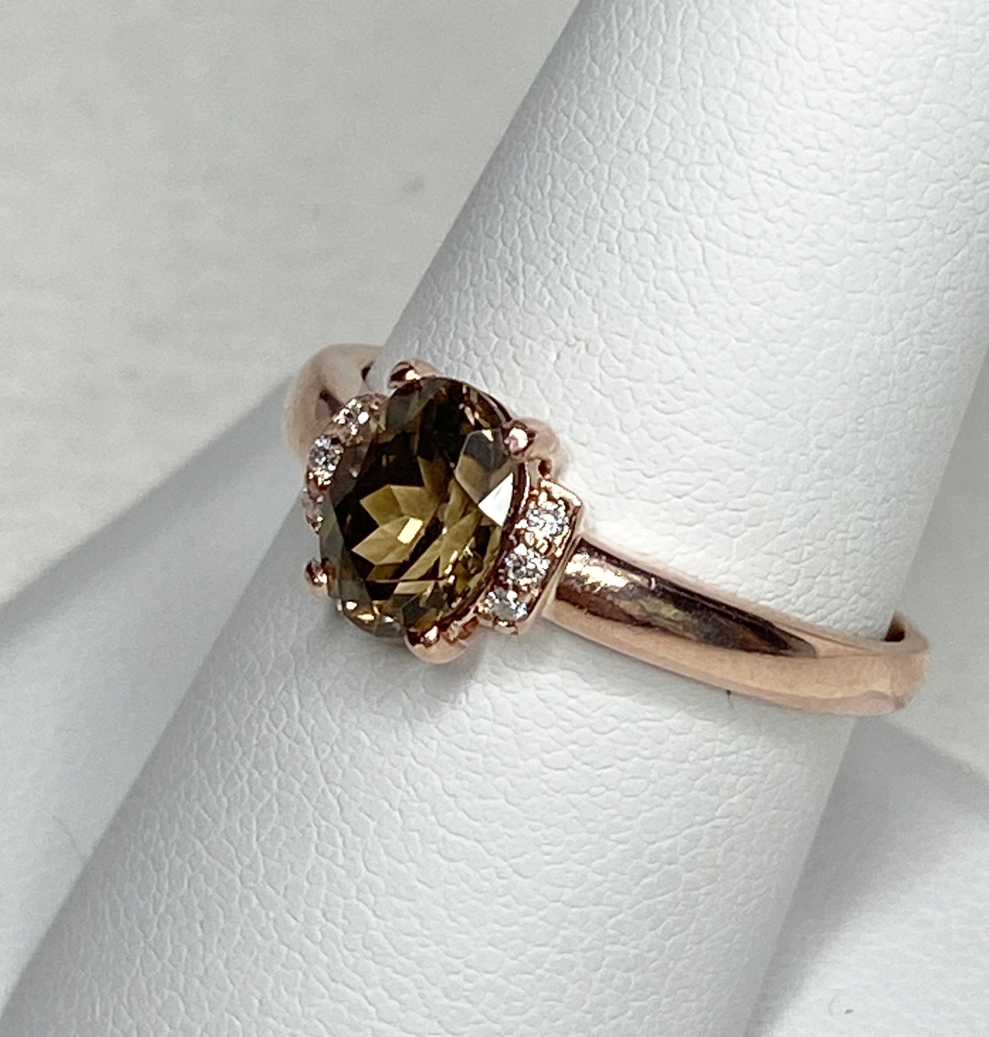 Oval natural zircon and diamond ring in rose gold.