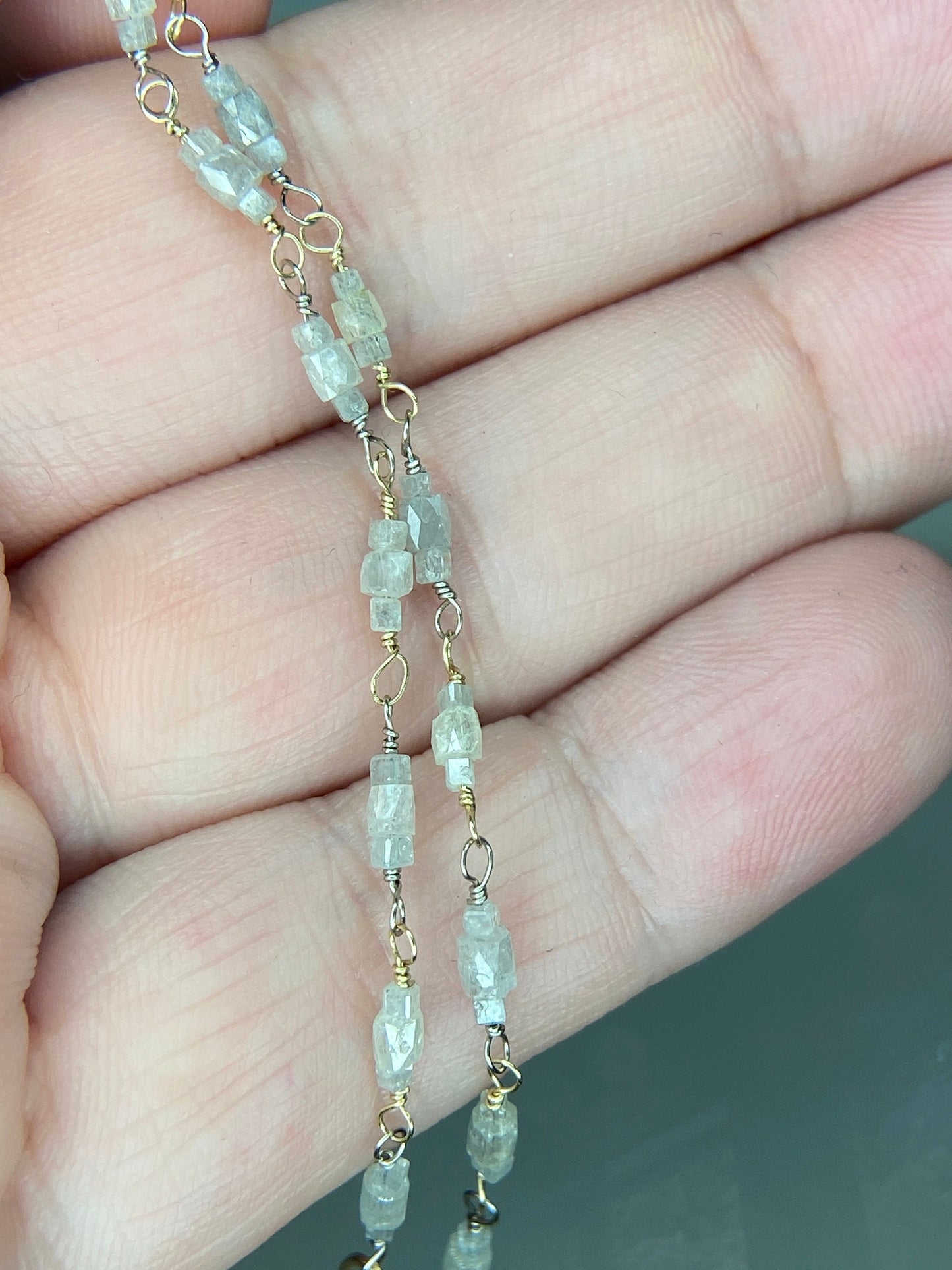 A two-tone gold bracelet with natural faceted diamond beads.