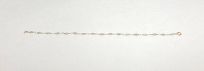 A delicate bracelet with faceted diamond beads and a gold clasp.