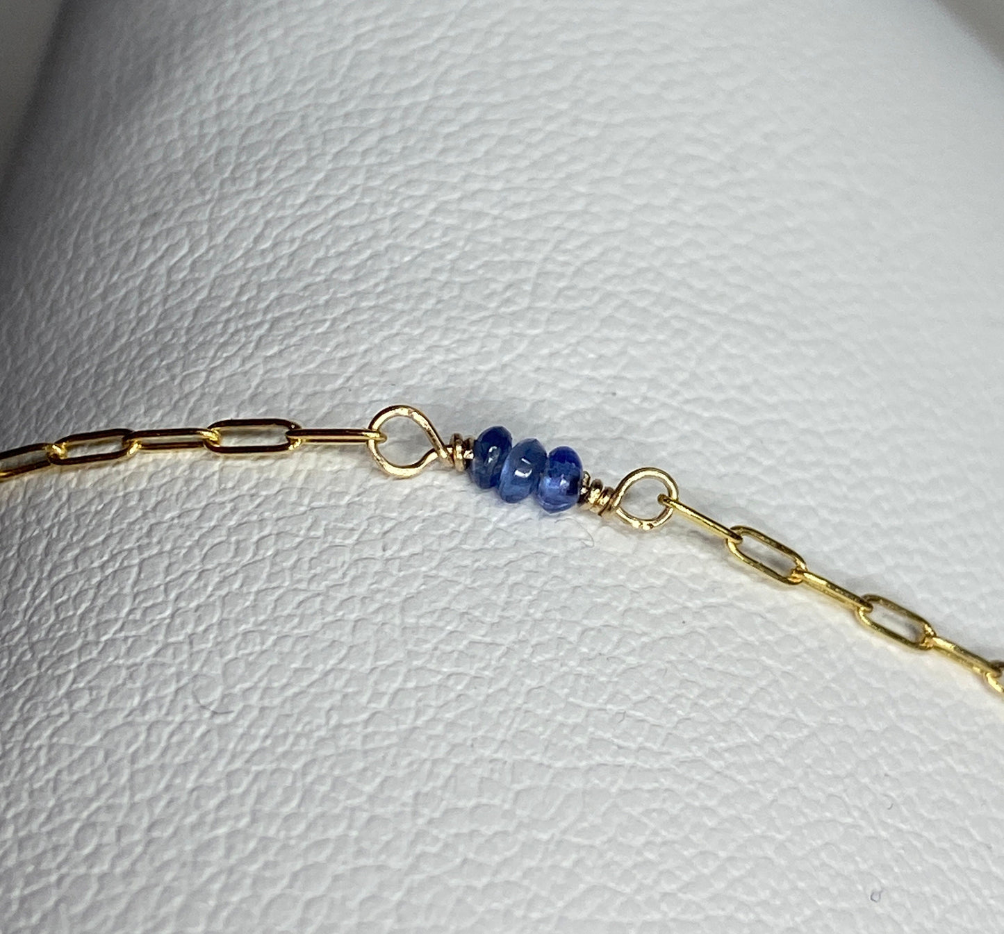 A 14k gold paperclip chain bracelet with untreated violet-blue Burmese sapphire beads.