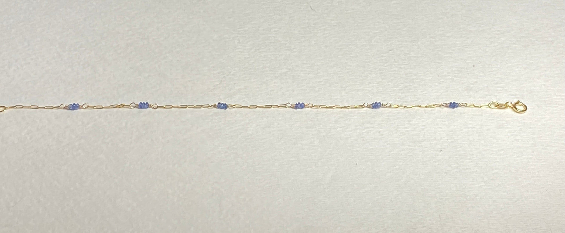 14k gold paperclip chain bracelet with untreated violet-blue Burmese sapphire beads.