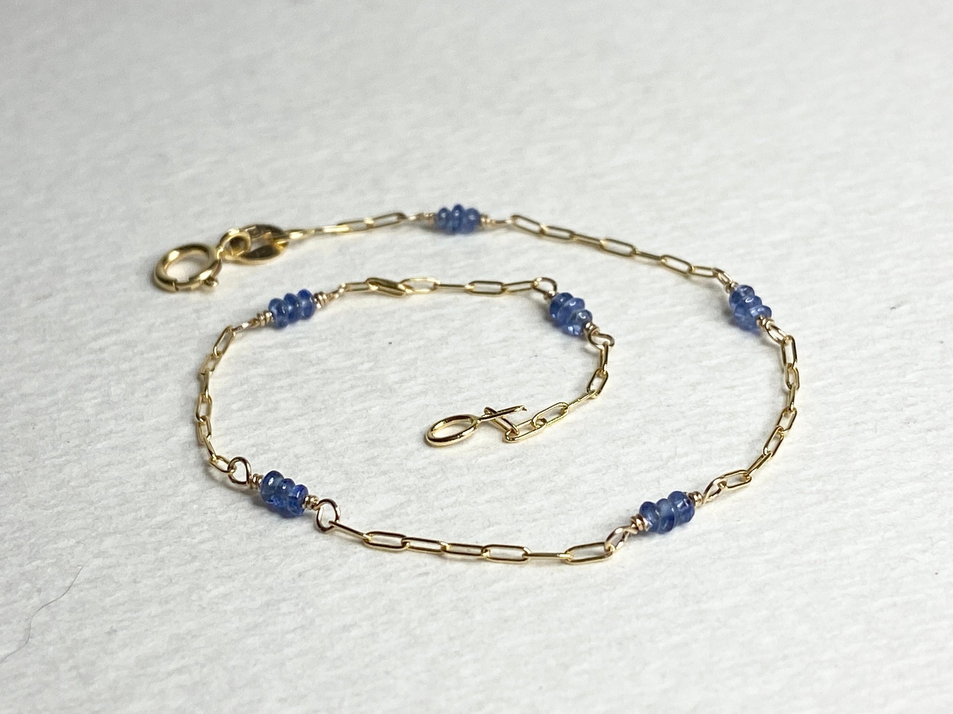 14k gold paperclip chain bracelet with untreated violet-blue Burmese sapphire beads.