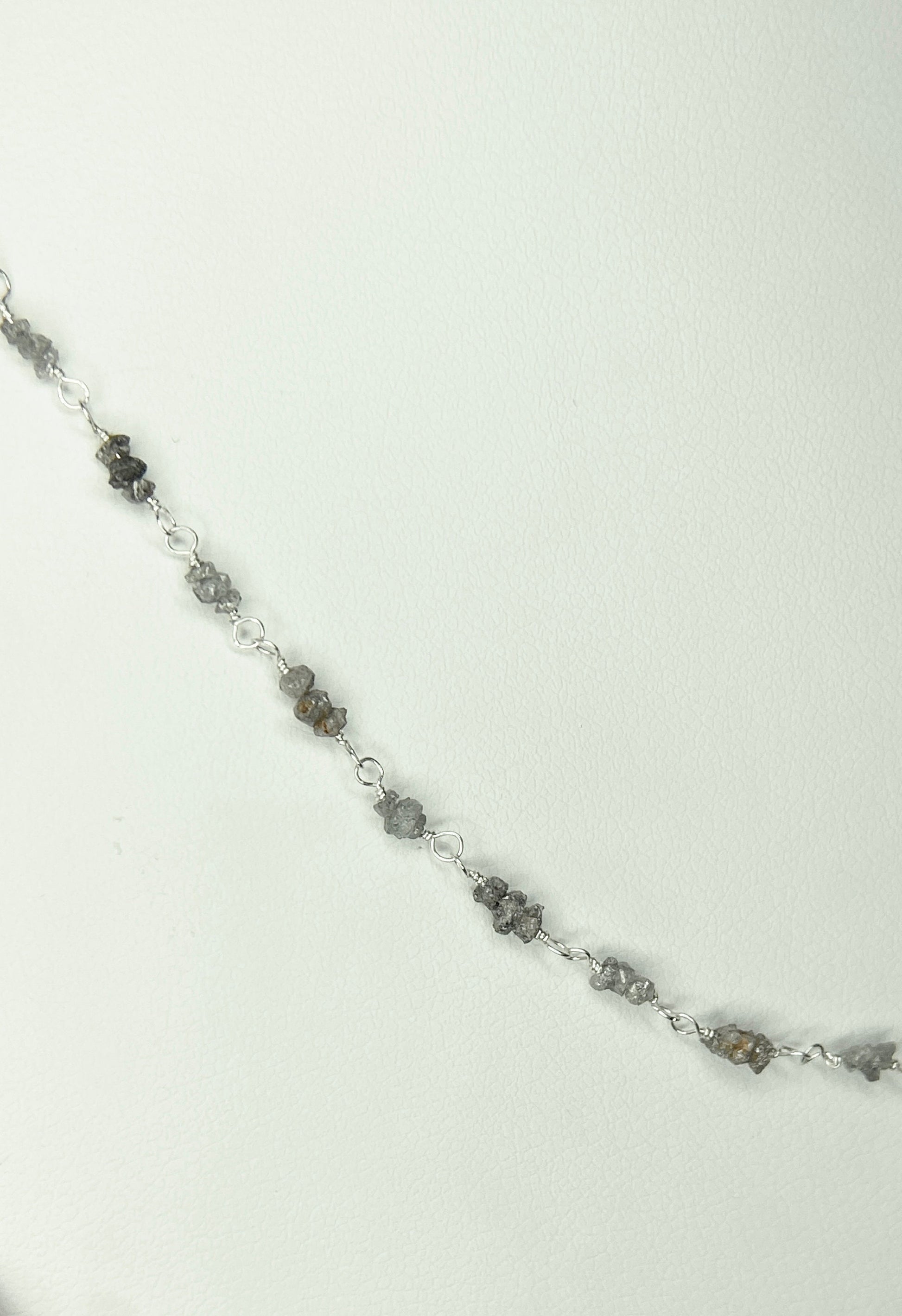 Sterling silver necklace with stations of rough natural silver and brown diamonds.