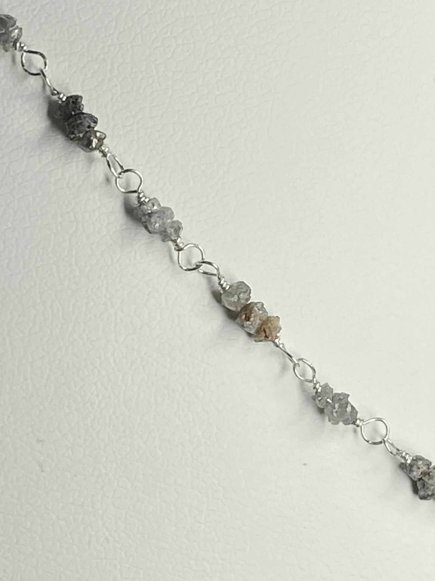 Sterling silver necklace with stations of rough natural silver and brown diamonds.