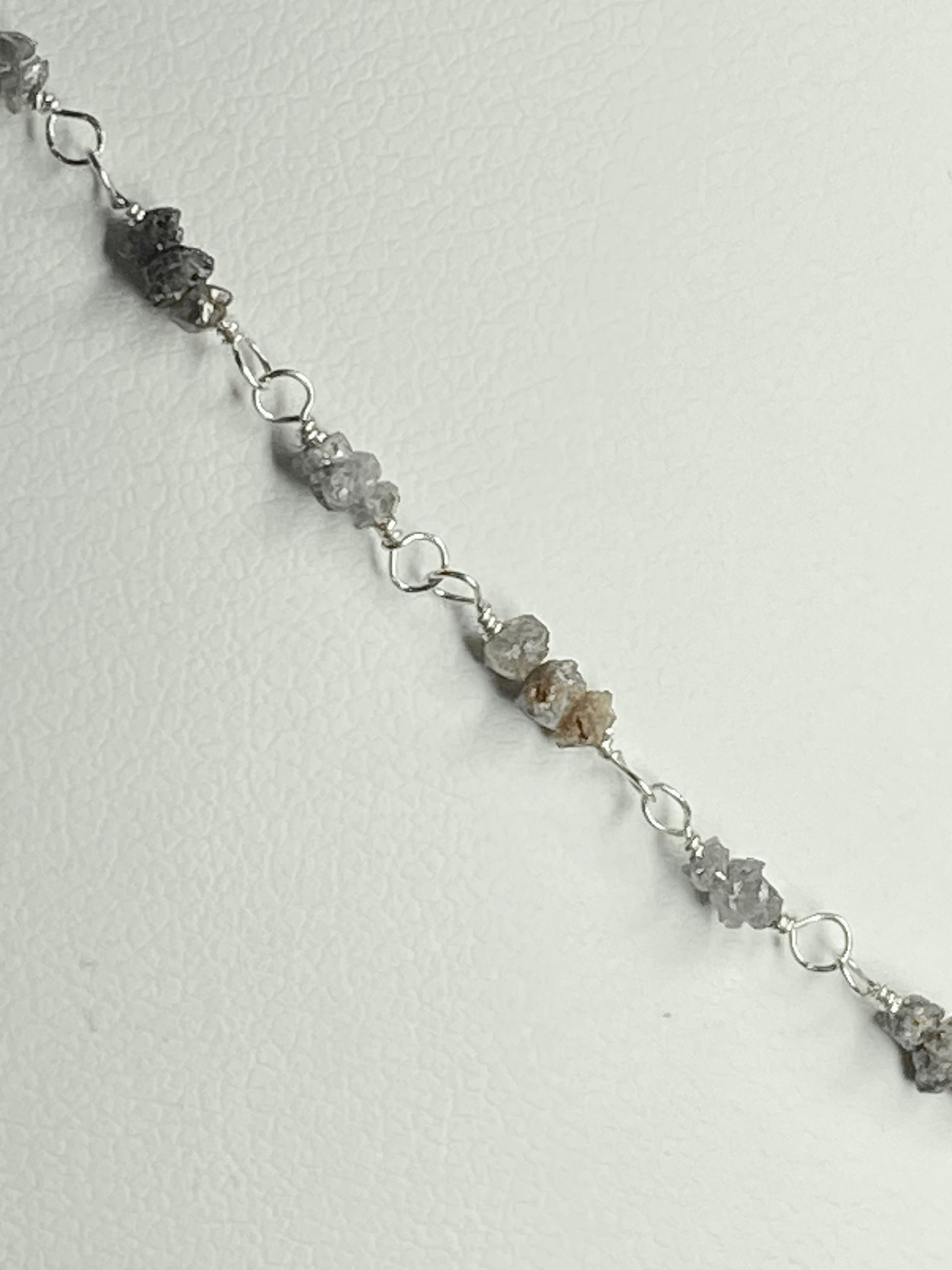 Sterling silver necklace with stations of rough natural silver and brown diamonds.