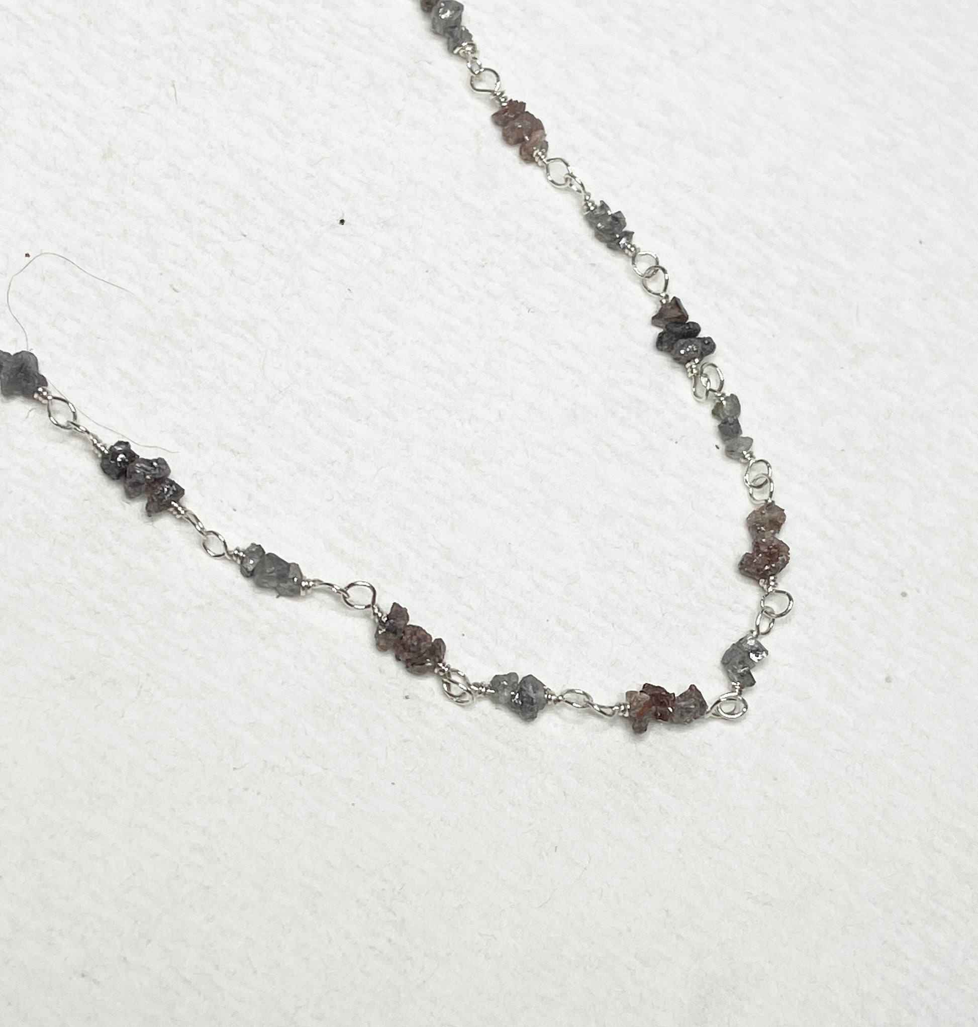 Sterling silver necklace with stations of rough natural silver and brown diamonds.