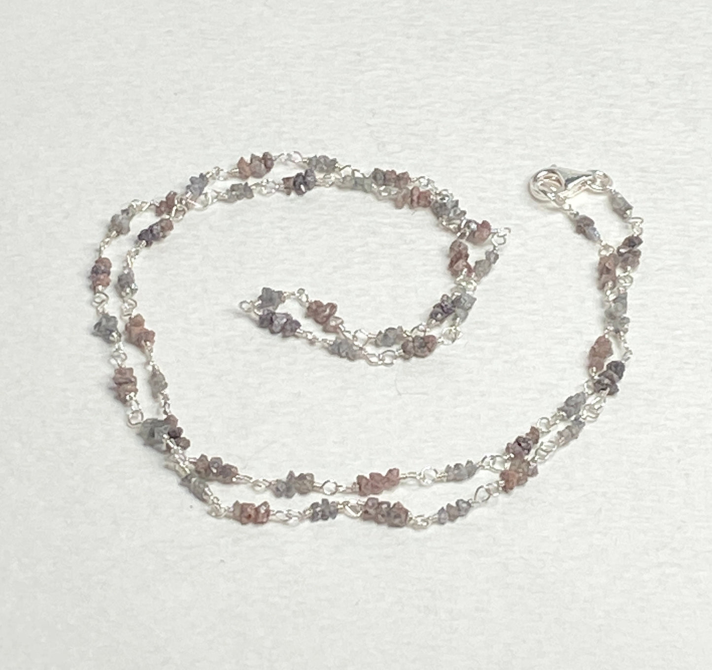Sterling silver necklace with stations of rough natural silver and brown diamonds.