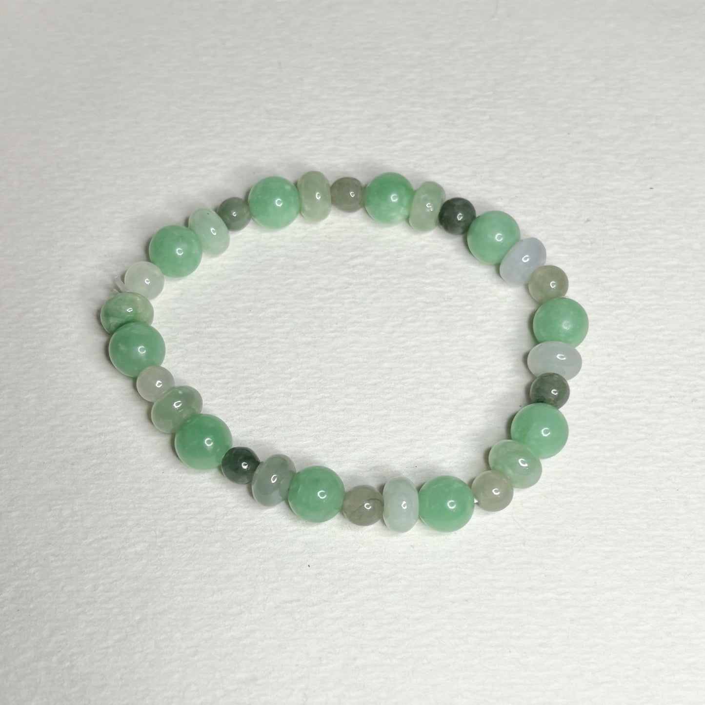 Burmese jadeite jade stretch bracelet with mixed green beads.