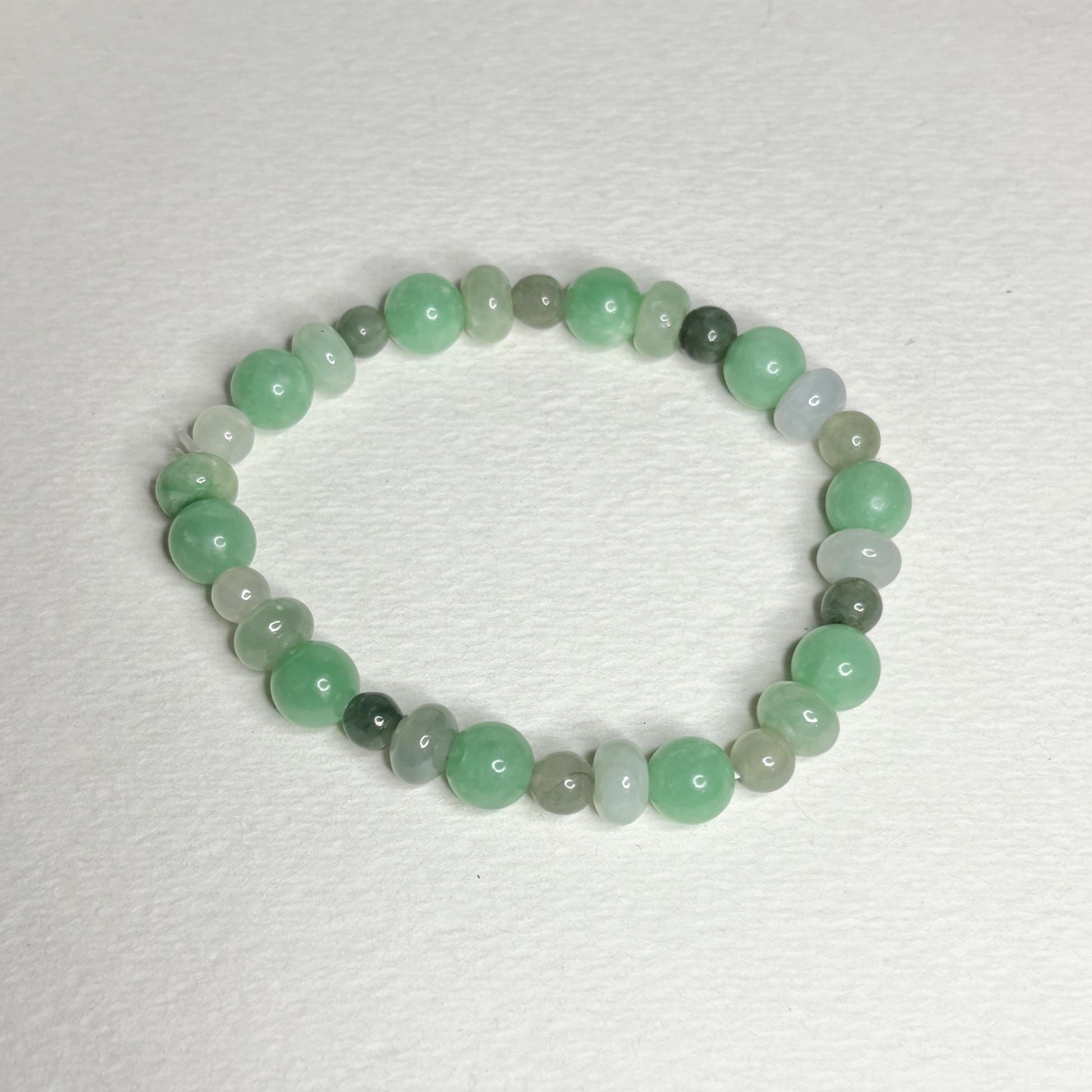 Burmese jadeite jade stretch bracelet with mixed green beads.