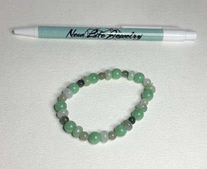 Burmese jadeite jade stretch bracelet with mixed green beads.