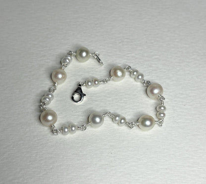 Sterling silver bracelet with cultured freshwater pearls.