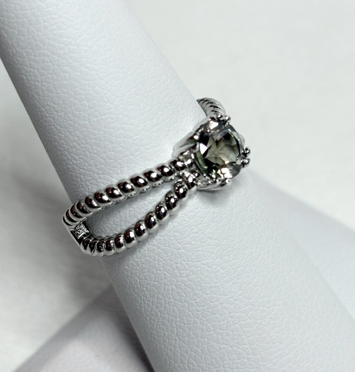 Sterling silver ring with a greenish Oregon sunstone and rope design.