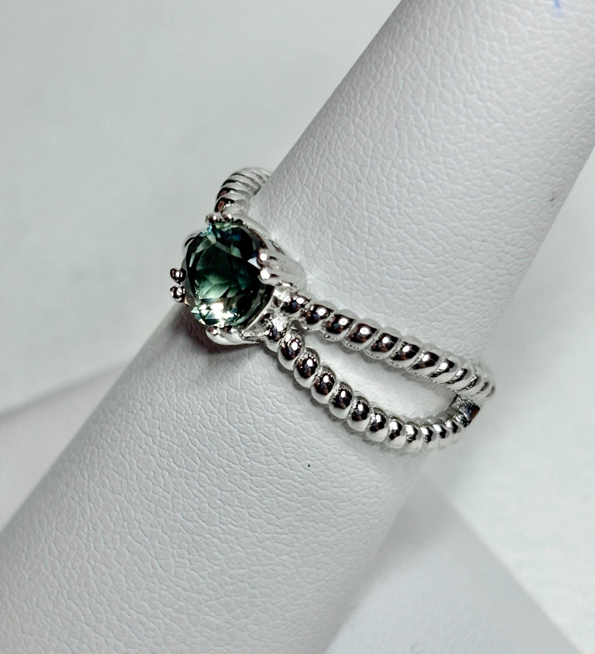 Sterling silver ring with a greenish Oregon sunstone and rope design.