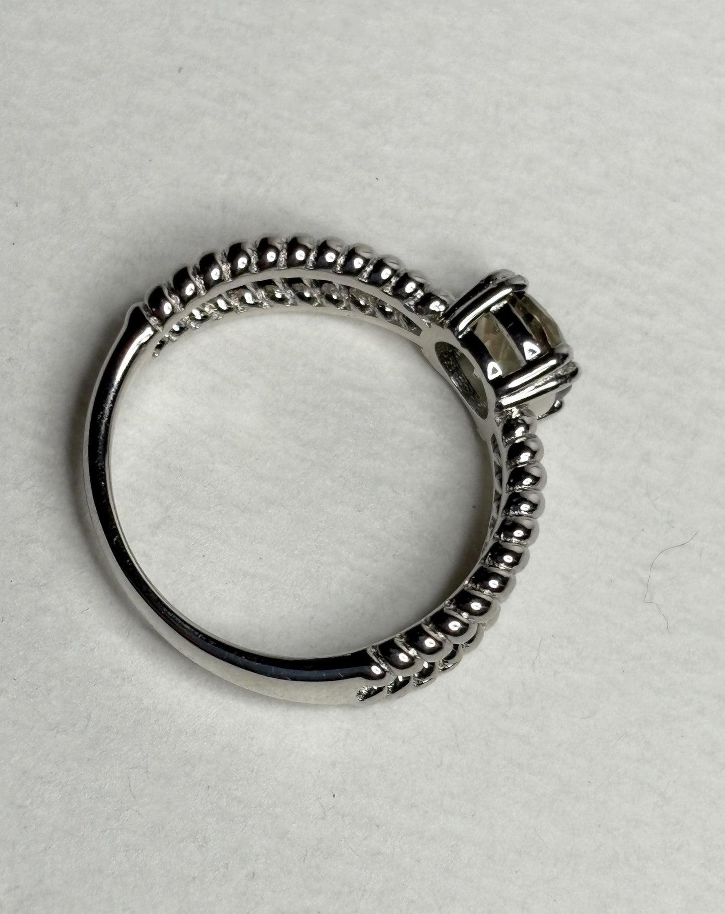 Sterling silver ring with a greenish Oregon sunstone and rope design.