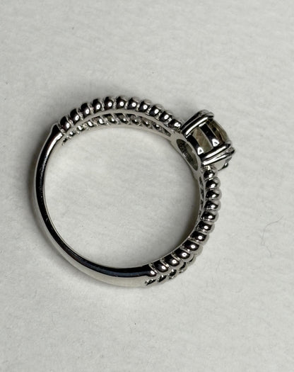 Sterling silver ring with a greenish Oregon sunstone and rope design.