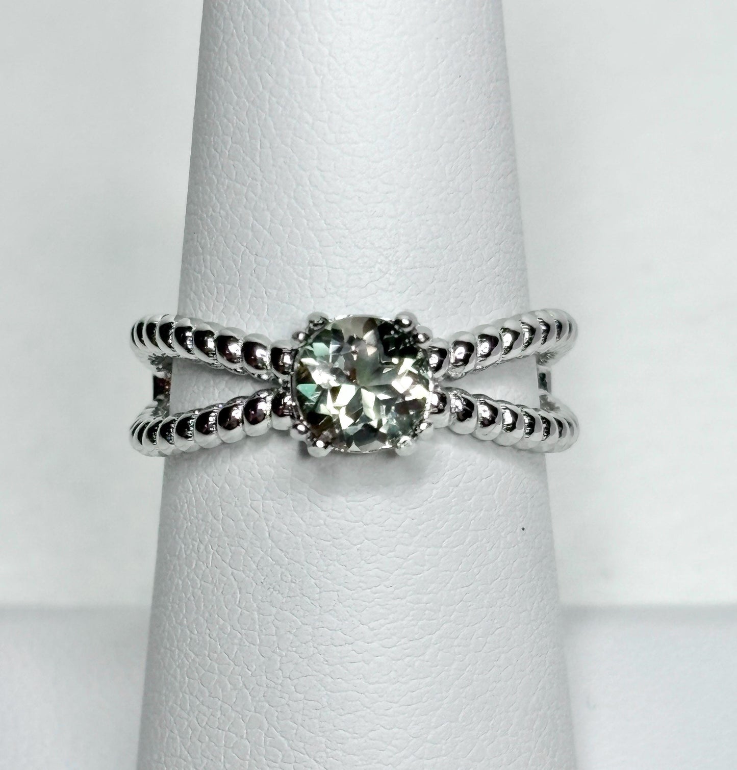 Sterling silver ring with a greenish Oregon sunstone and rope design.