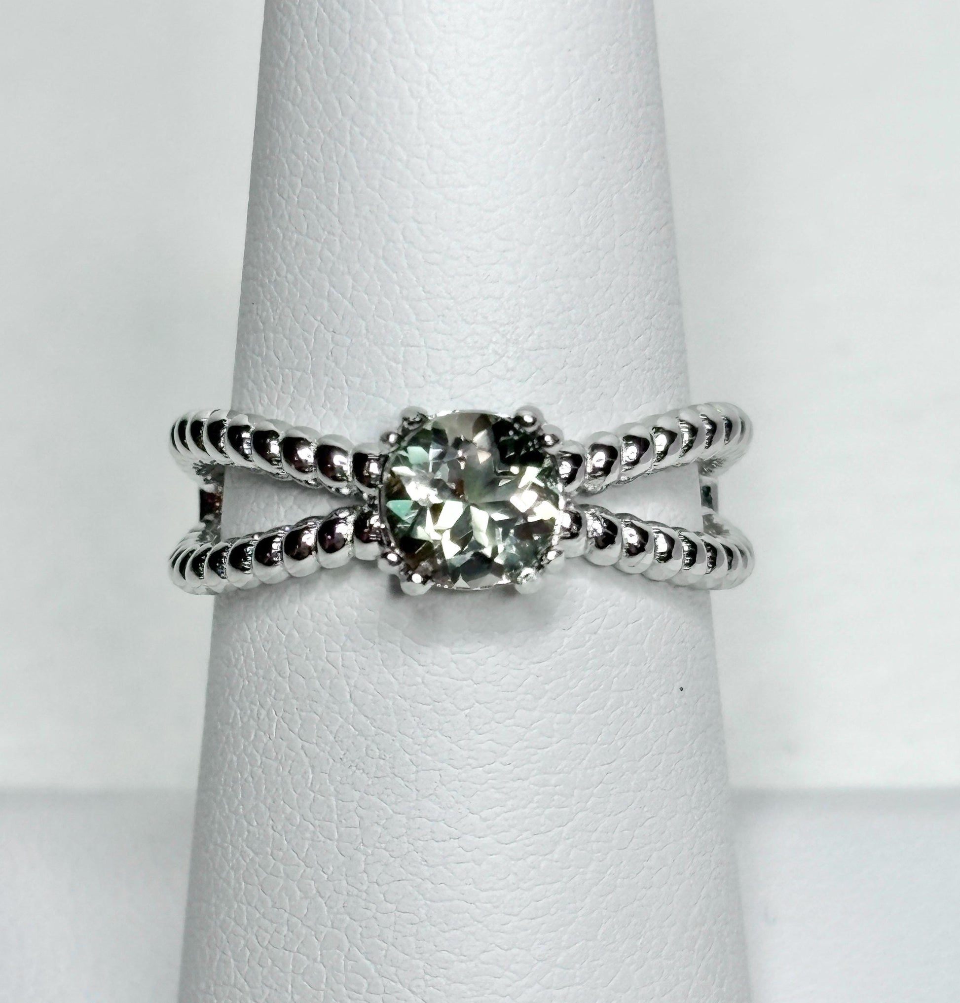 Sterling silver ring with a greenish Oregon sunstone and rope design.