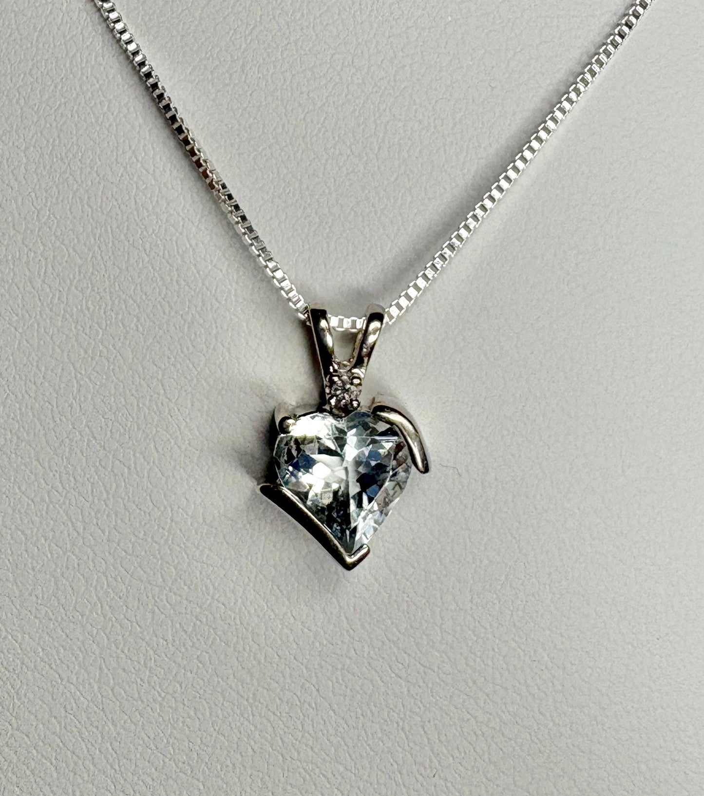 Aquamarine and diamond heart pendant on a sterling silver chain.