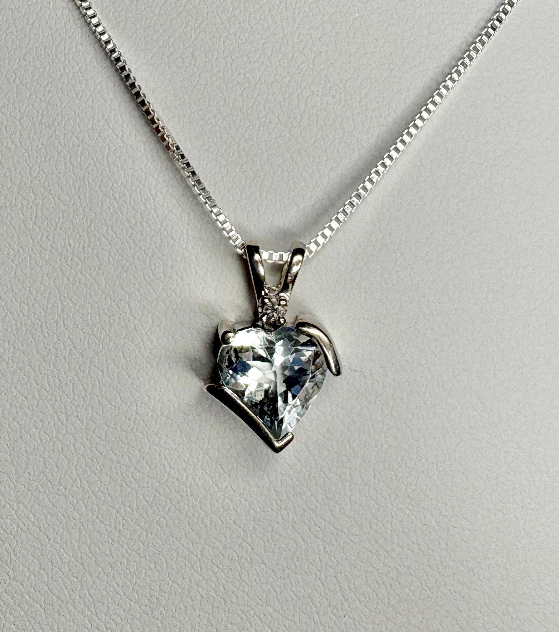 Aquamarine and diamond heart pendant on a sterling silver chain.