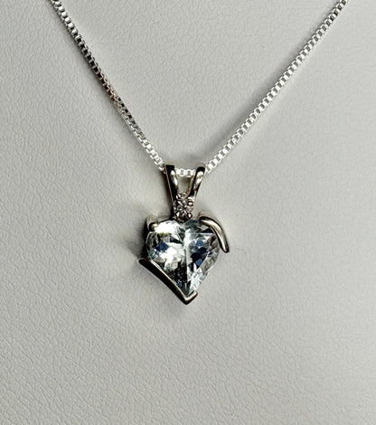 Aquamarine and diamond heart pendant on a sterling silver chain.
