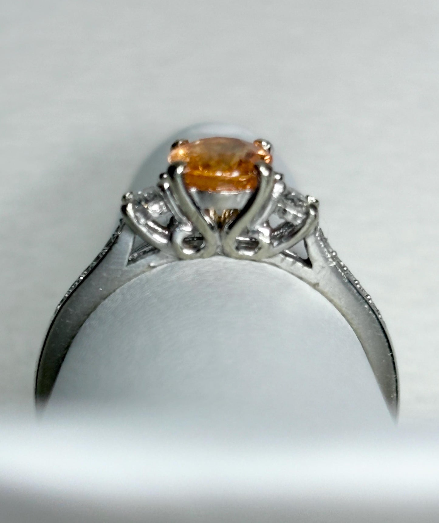 A 10k white gold ring with a Fanta orange spessartite garnet and diamonds.