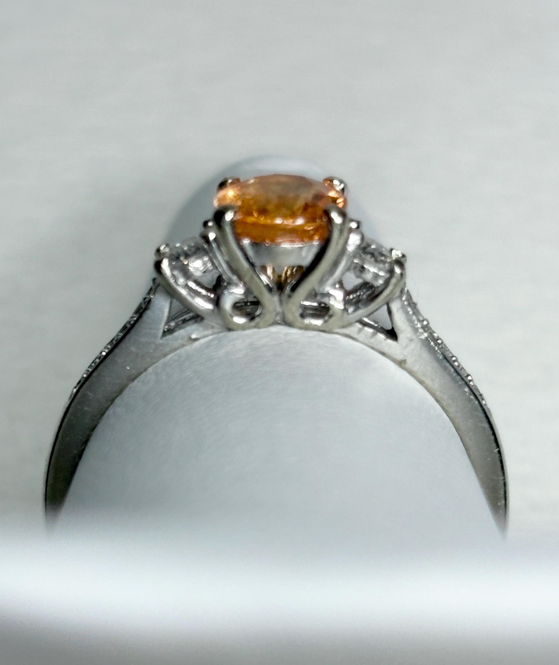 A 10k white gold ring with a Fanta orange spessartite garnet and diamonds.