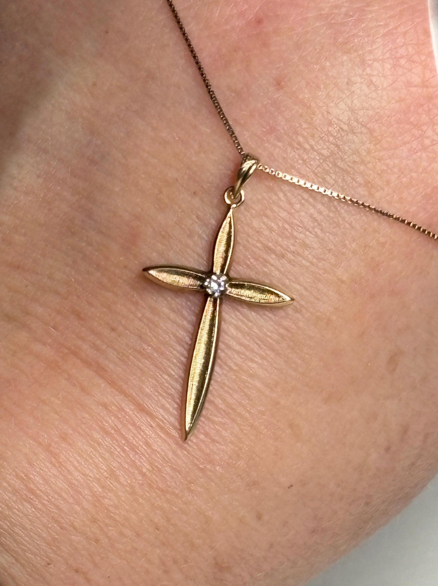 Diamond cross pendant necklace on a 10k box chain.