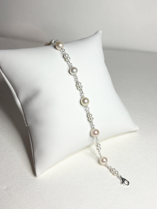 Sterling silver bracelet with alternating cultured freshwater pearls.